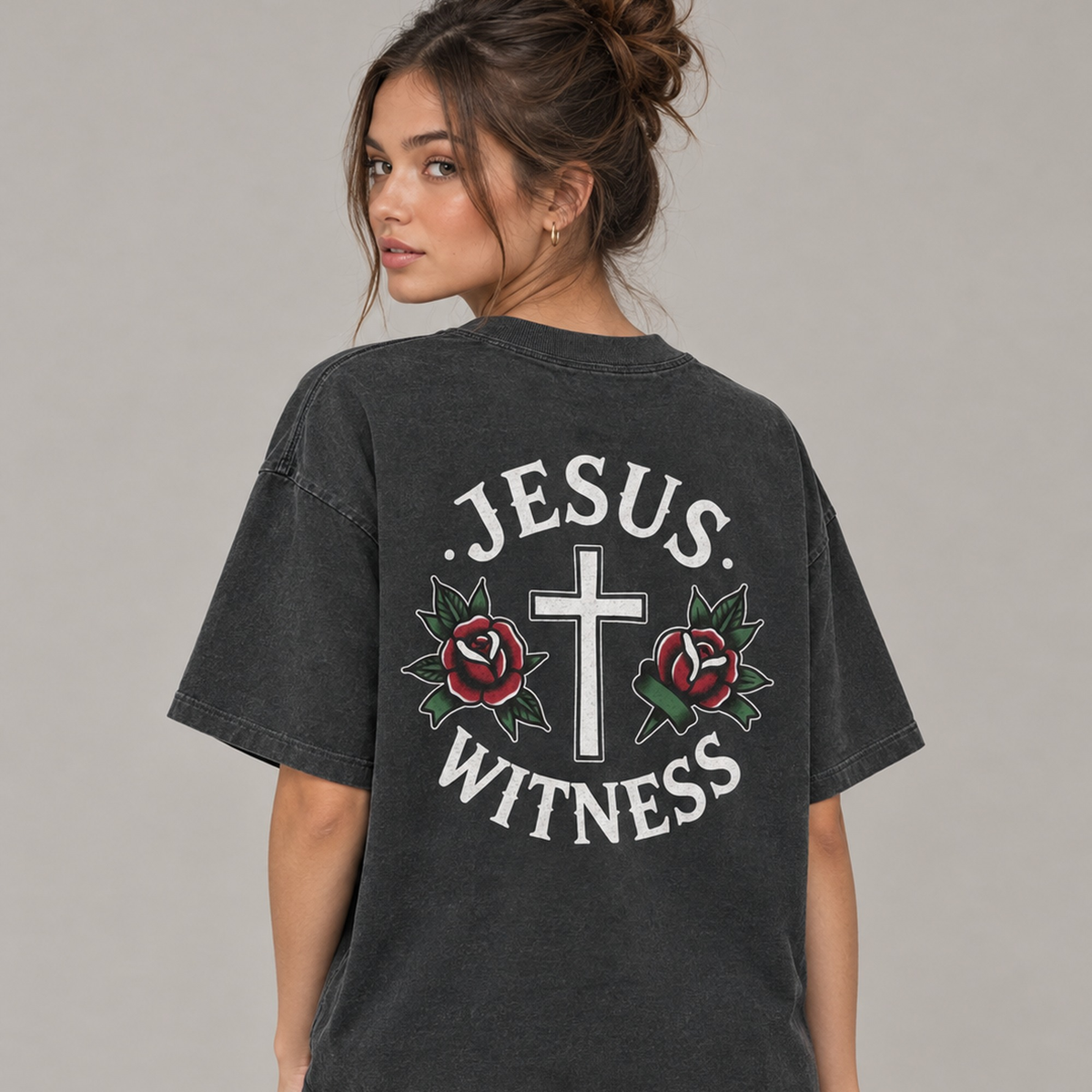 Woman wearing washed black Jesus Witness tee, back view with cross and roses