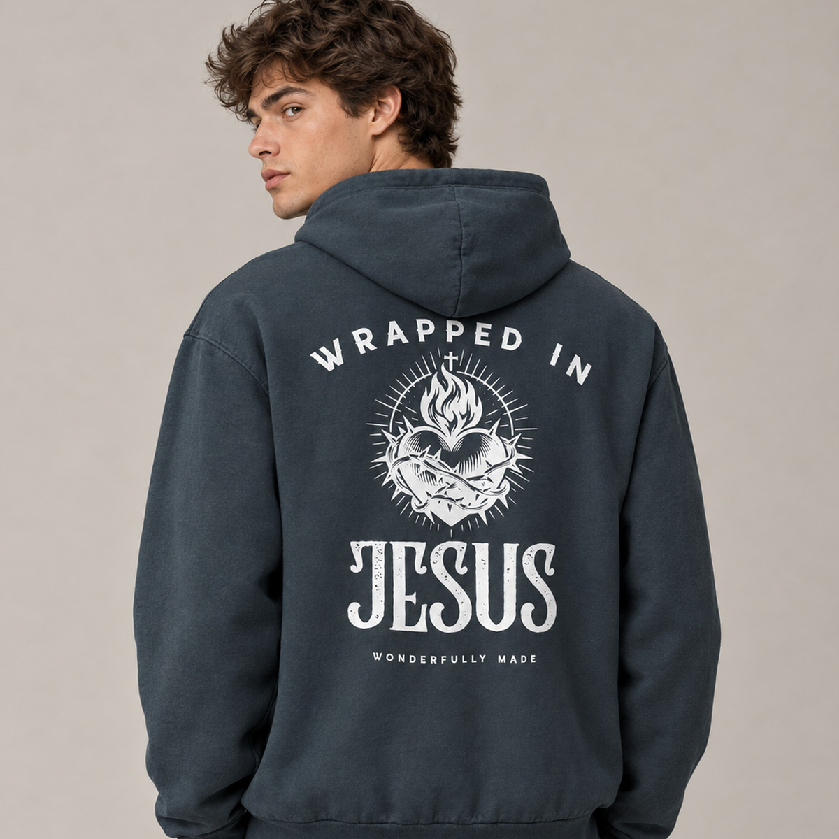 Man wearing midnight navy Sacred Heart oversized hoodie, back view