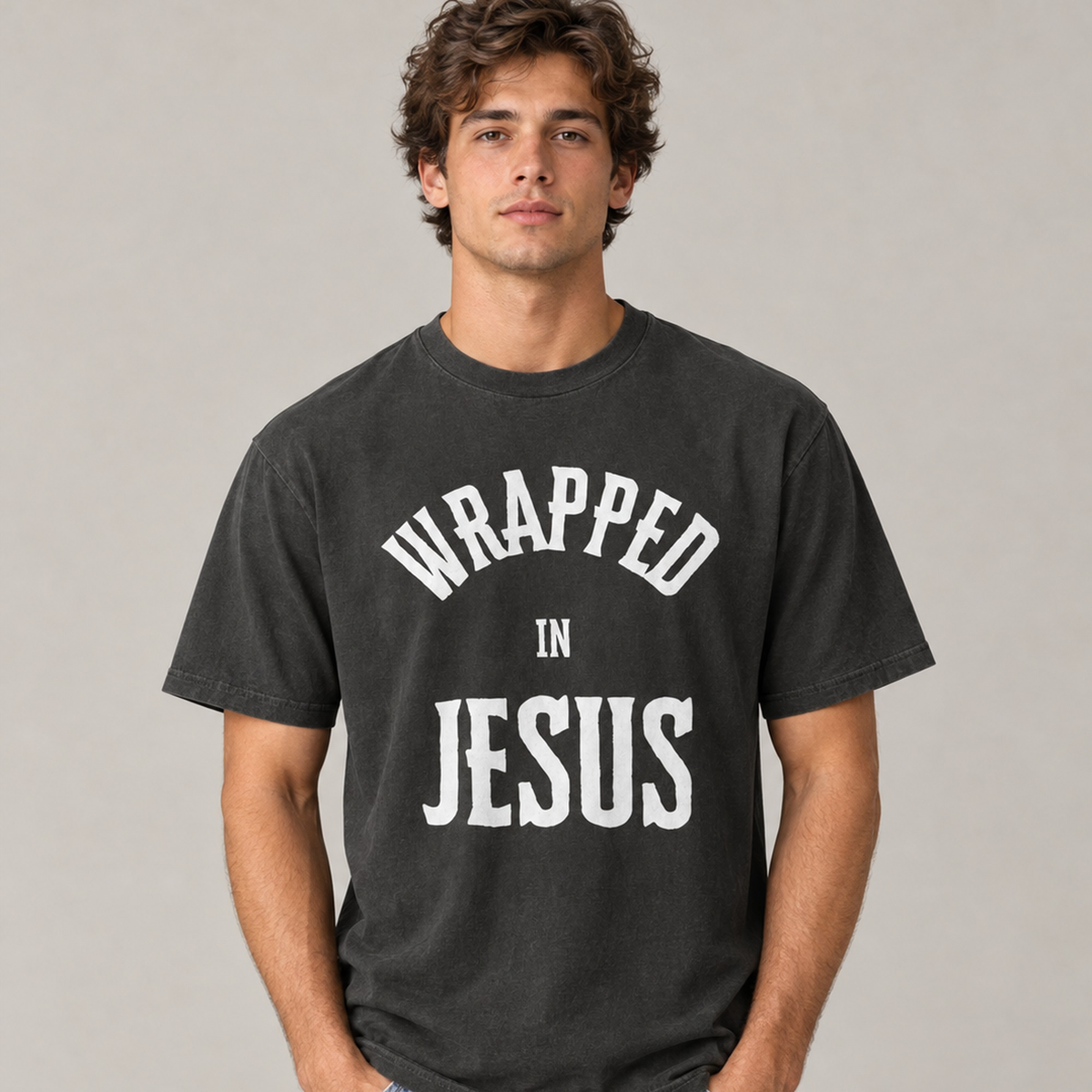 Man wearing black rock Wrapped In Jesus John 1:14 vintage tee, front view