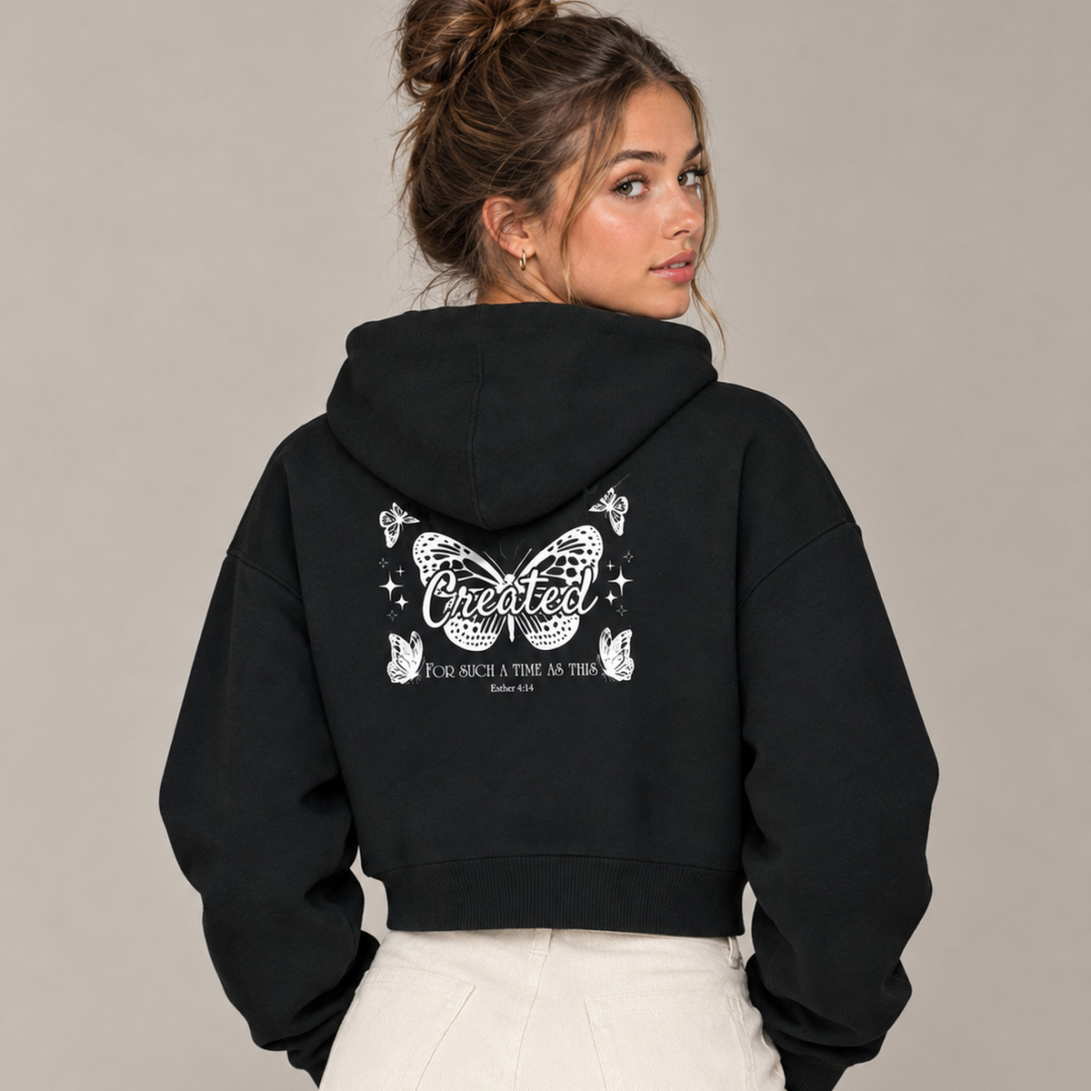 Woman wearing black Created butterfly cropped zip-up hoodie, back view with Esther 4:14