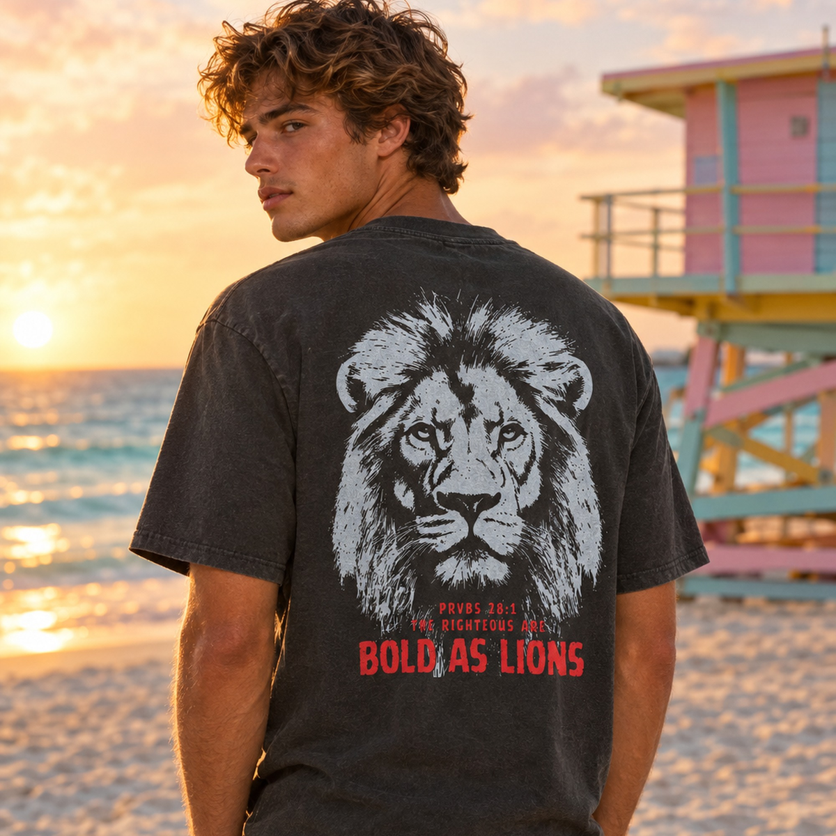 Man wearing black Bold As Lions Proverbs 28:1 vintage tee on Miami Beach by a lifeguard tower